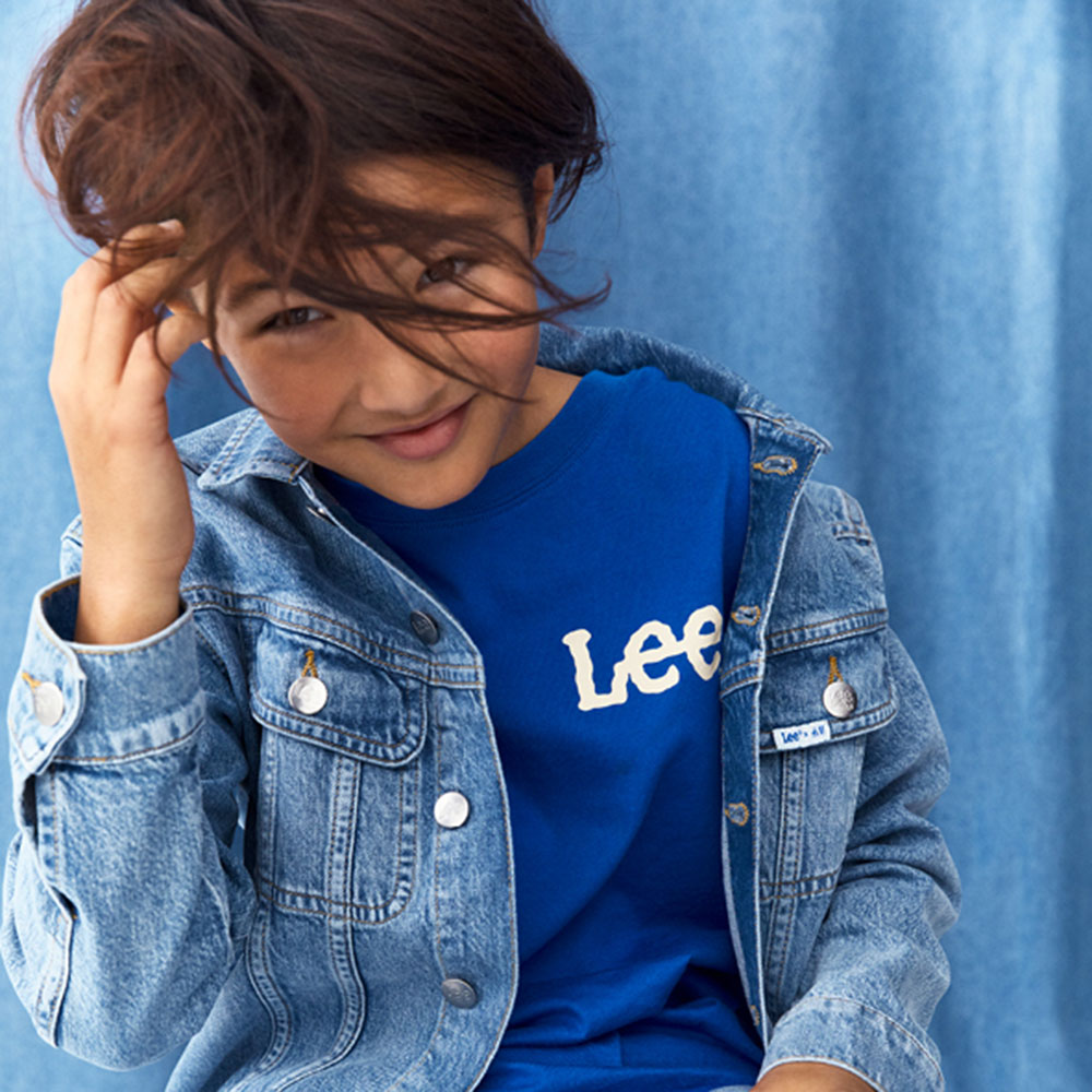 Boy in blue denim jacket and dark blue Lee branded T Shirt
