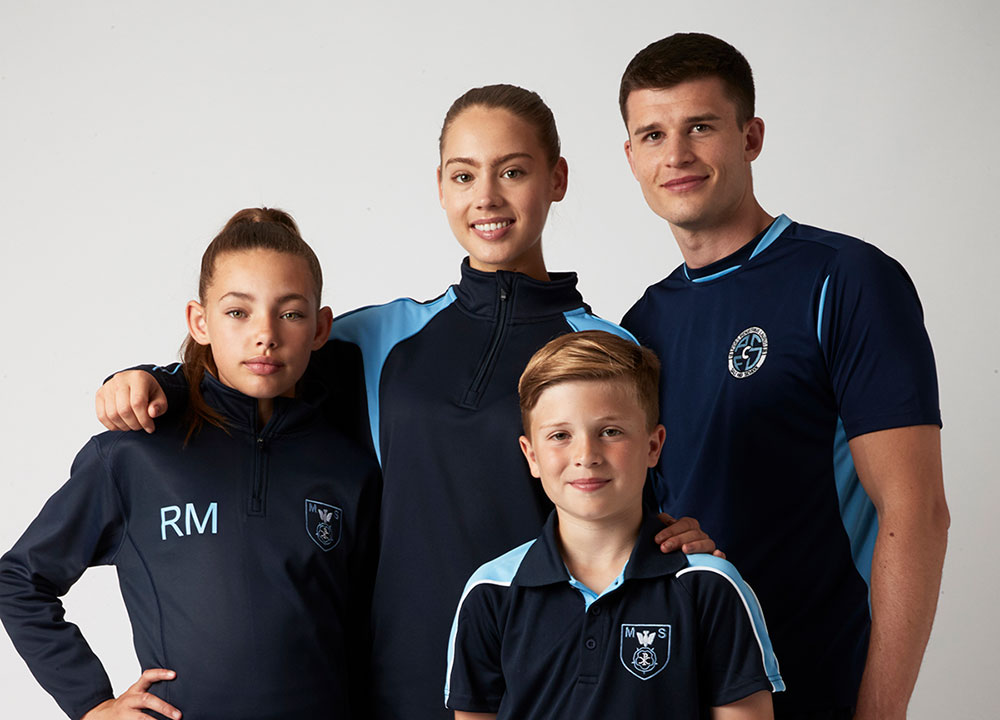 Four school children in iGEN dark blue sportswear by Chadwick Textiles