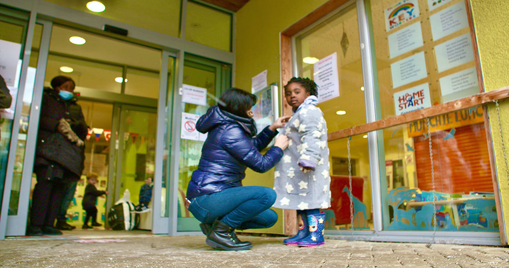 A young girl trying on a new jacket