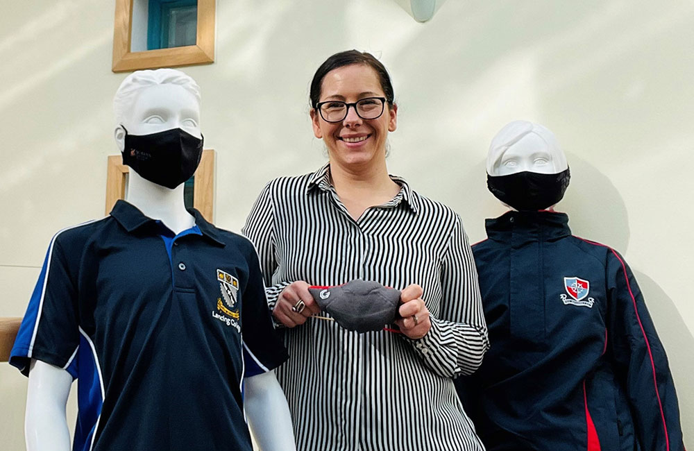 Woman in stood next to two mannequins in face coverings