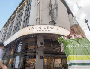 John Lewis outside stor image with lady carrying Waitrose plastic bag