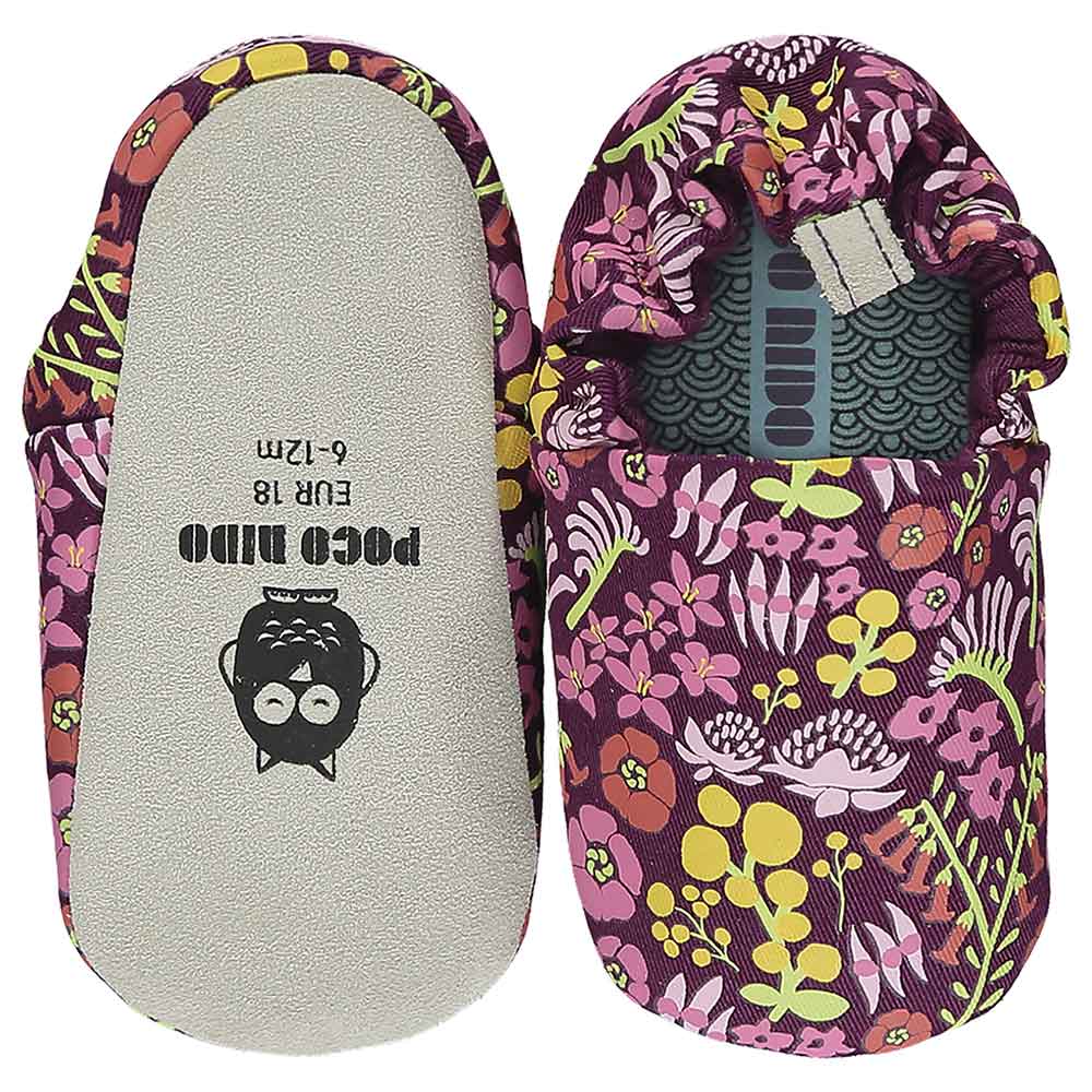 A pair of Poco Nido shoes with a flowery pattern on them