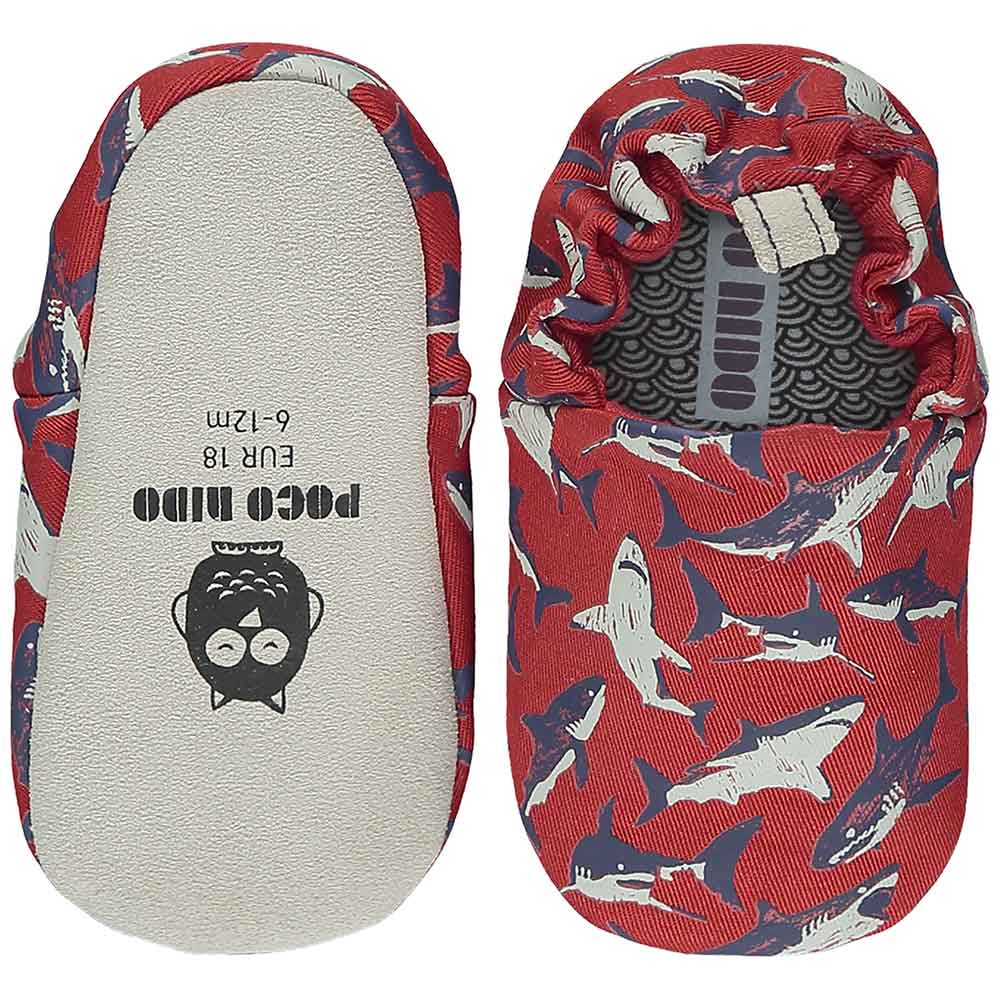 A pair of Poco Nido shoes with sharks on them
