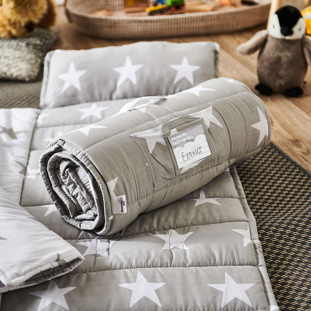 Grey rolled up baby nap mats with white star design