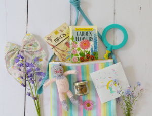 Colourful bag by Inch Blue accessories hanging on wooden door