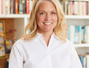 Head and shoulder image of Kelly Lees, blonde hair, wearing white blouse