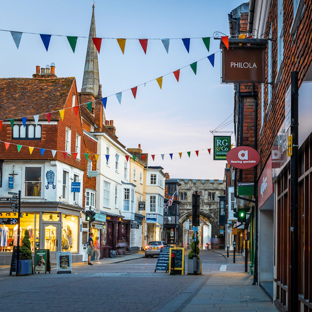 Salisbury high street with shops and church spire