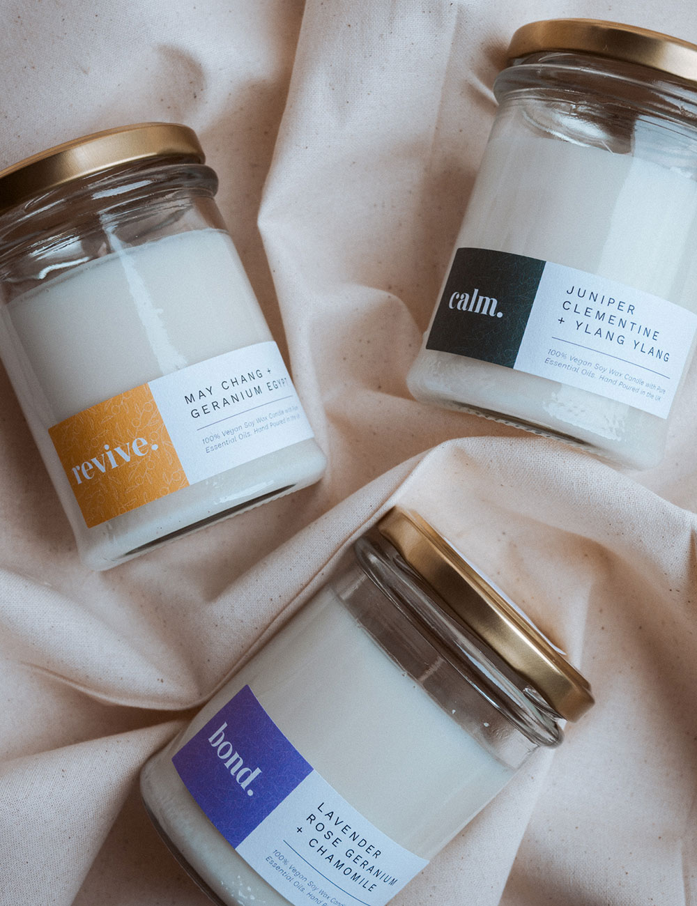 three little glass jars with scented candle inside