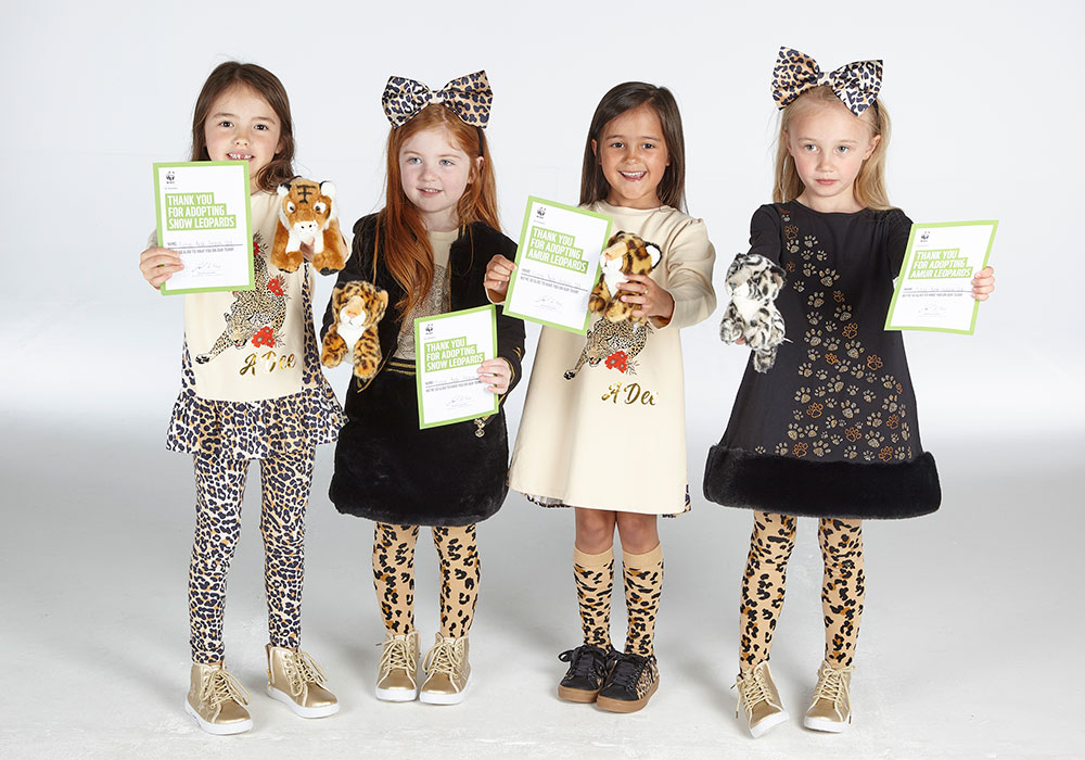 Children holding WWF adoption certificates wearing the new Wild About Big Cats collection