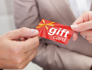 Red gift card held by two hands