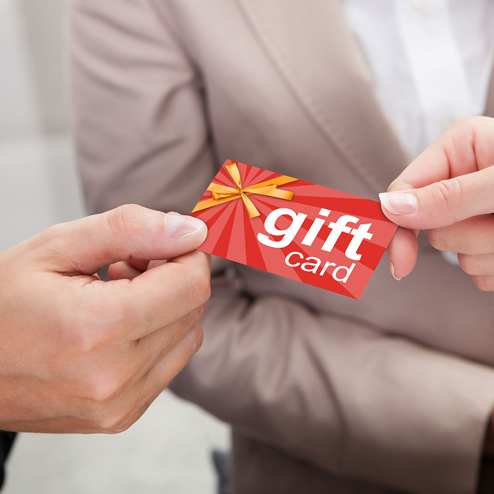 Red gift card held by two hands