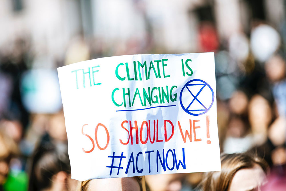 A climate is changing sign held up at a demonstration