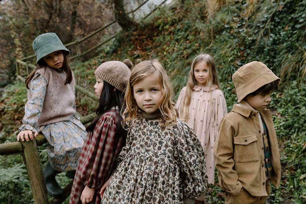 Five children stood in a woodland setting