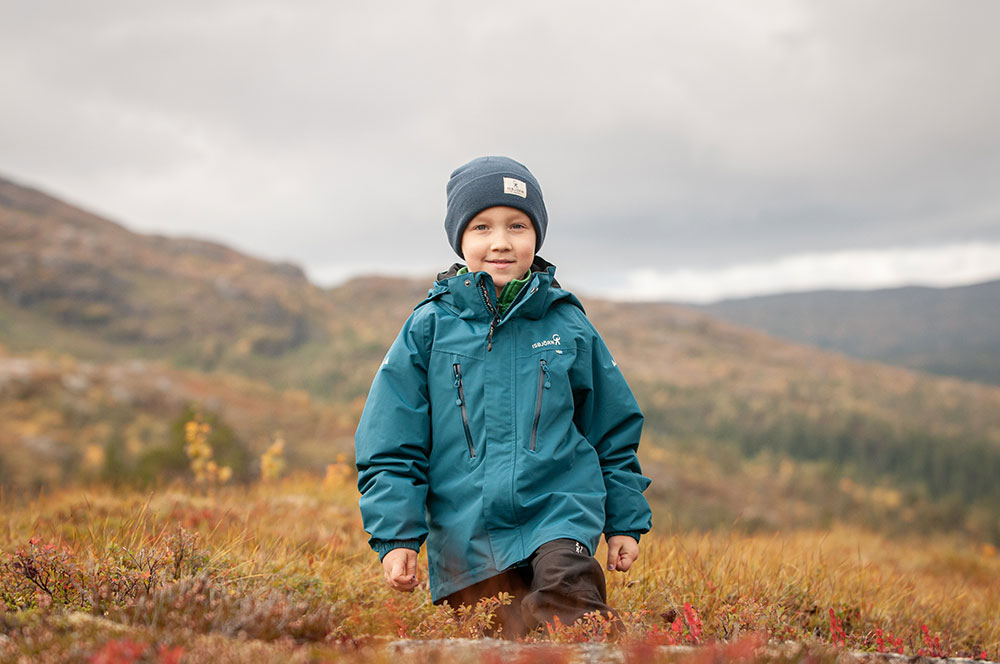 A young boy wearing outdoor clothing