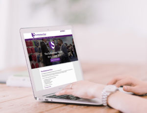 A woman viewing The Schoolwear Show website on a laptop