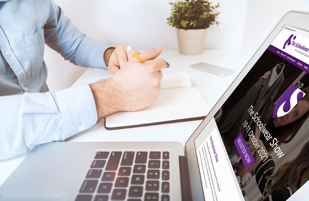 Man viewing The Schoolwear Show website on his laptop