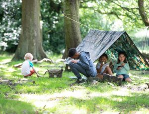 Four children camping in the outdoors