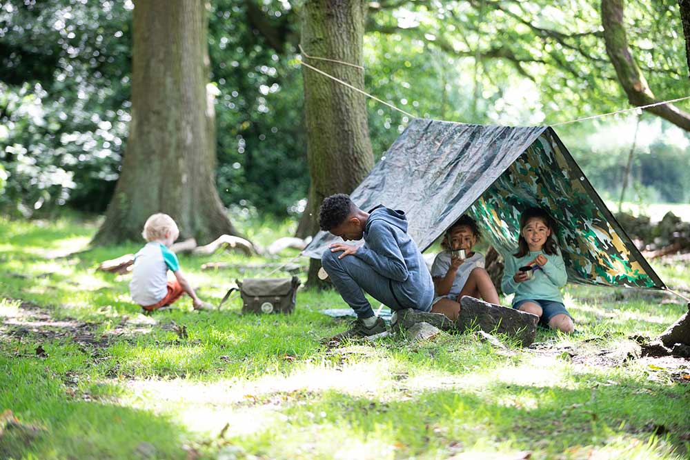 Four children camping in the outdoors