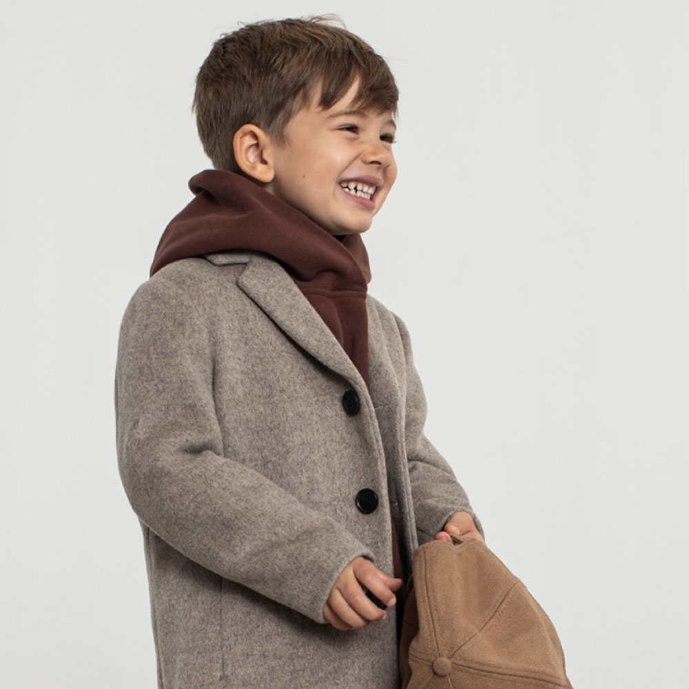 Young boy in grey Reiss coat and brown scarf