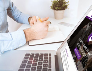 Man viewing The Schoolwear Show website on his laptop