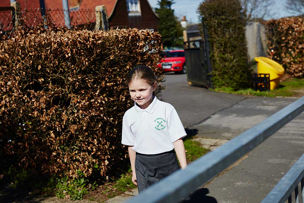 A young girl walking to school