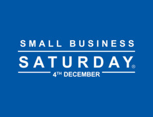 Blue sign with white writing saying Small Business Saturday