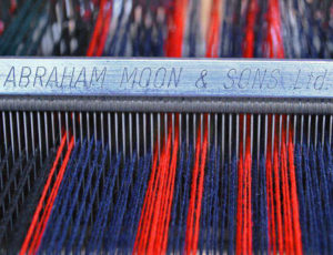 red and blue wool on a machine in a factory