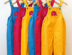 Yellow red and blue dungarees by Babipur on hangers