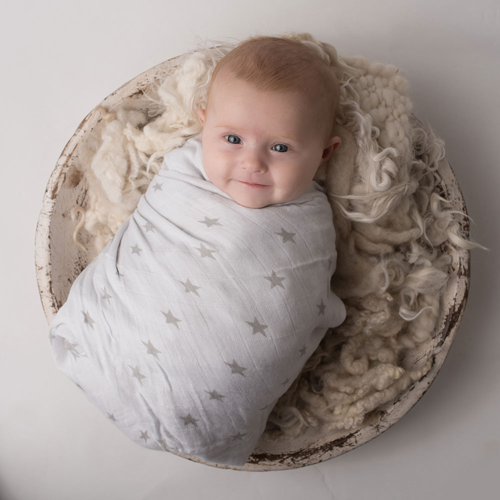 Baby wrapped in Ziggle grey swaddle