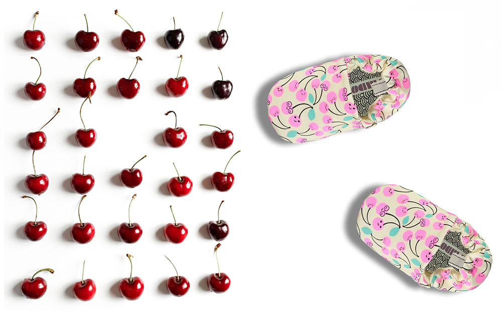 Cherry pring baby shoes and rows of red cherries