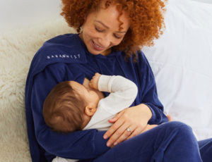 Mother in blue Baba West maternity loungewear holding her baby