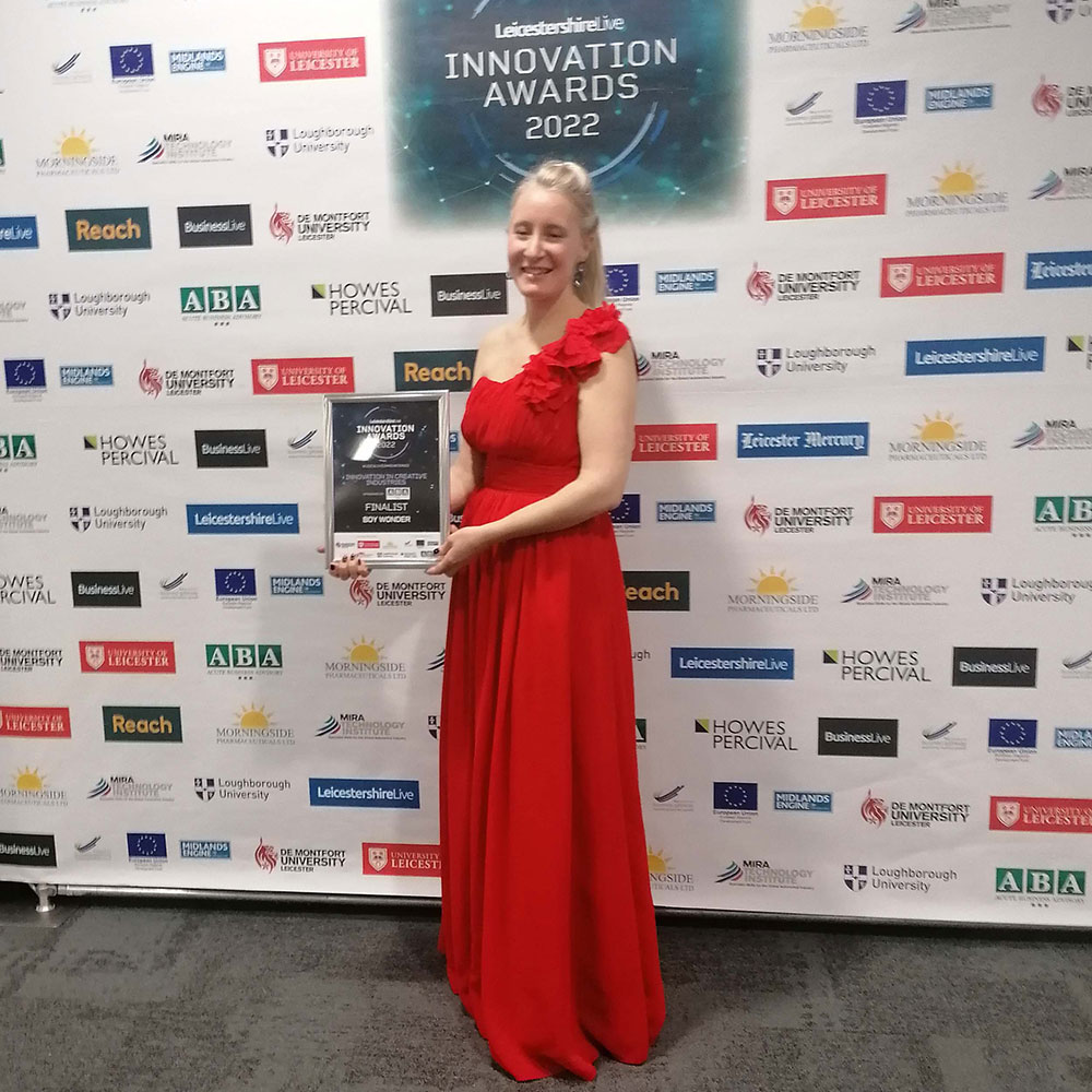 Lady in red dress accepting an innovation award