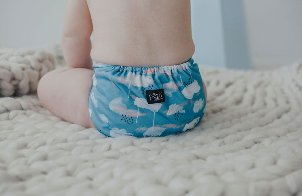 Baby wearing blue reusable nappy