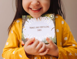 girl in yellow dress holding enchanted learning cards