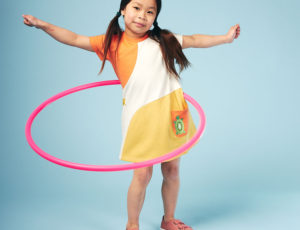 Young girl wearing a dress by Lucy & Sam doing hoola Hoop
