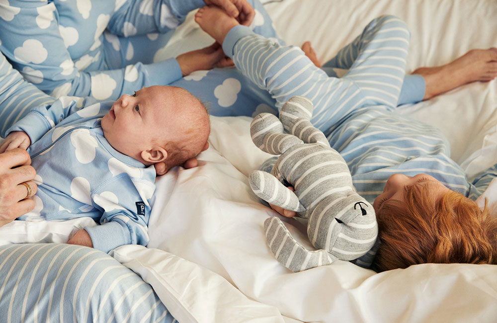 baby and child wearing pale blue pjs with white cloud pattern