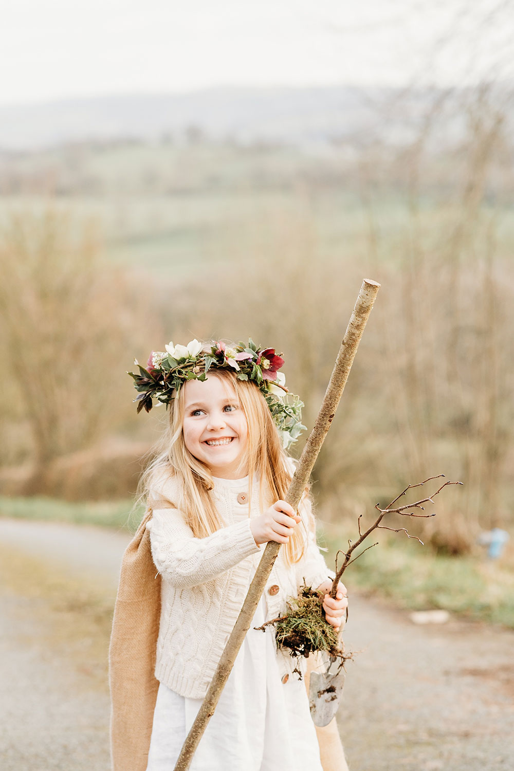 A young girl holding a long stick