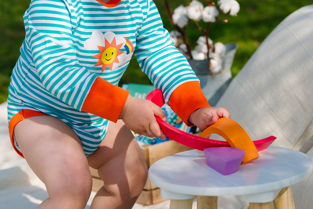 A young baby playing with coloured shapes