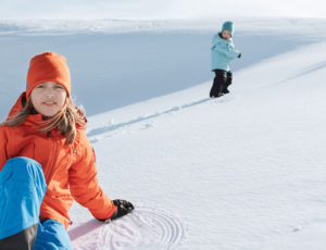 Two children playing in the snow