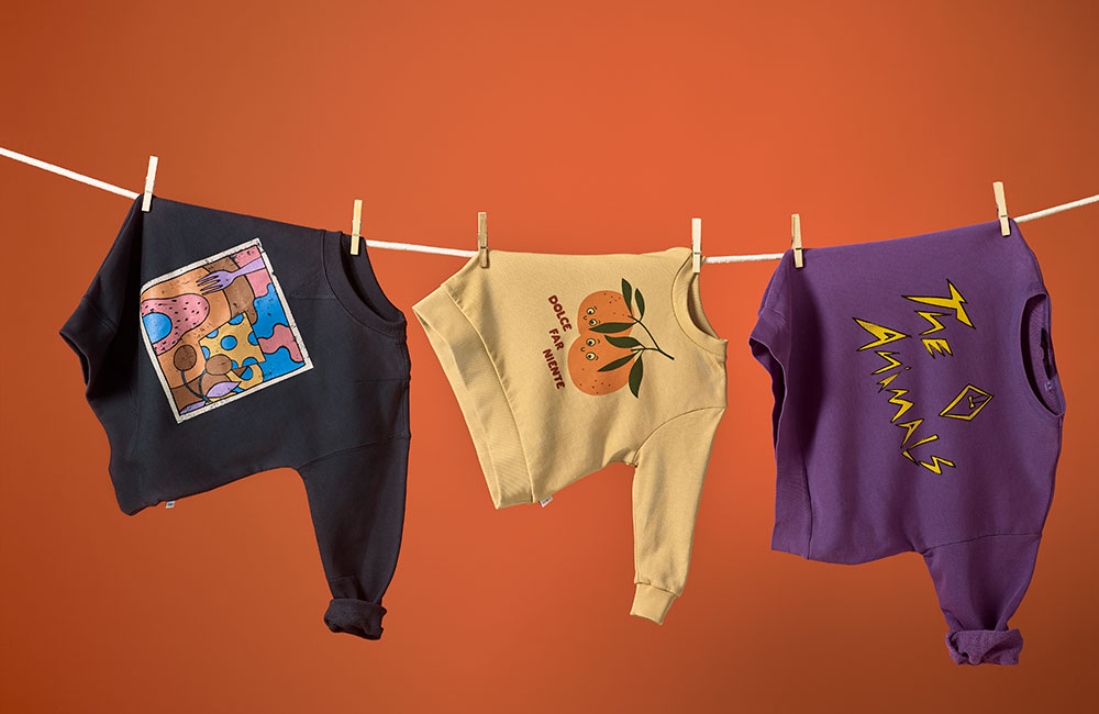 colourful kidwear by dotte haning on clothes line against dark orange background