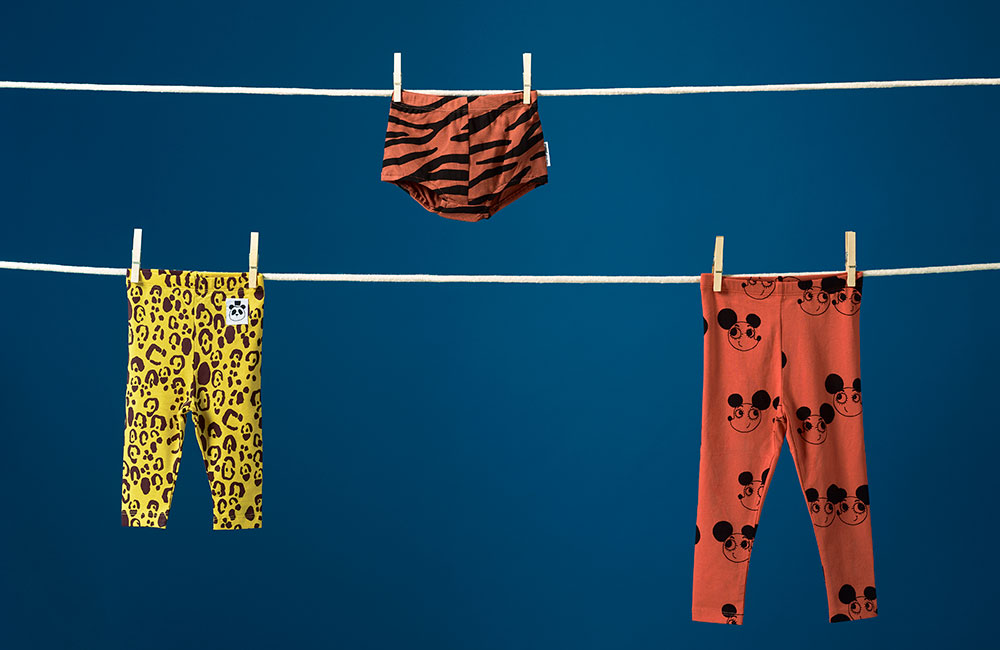 colourful kidwear by dotte haning on clothes line against dark blue background