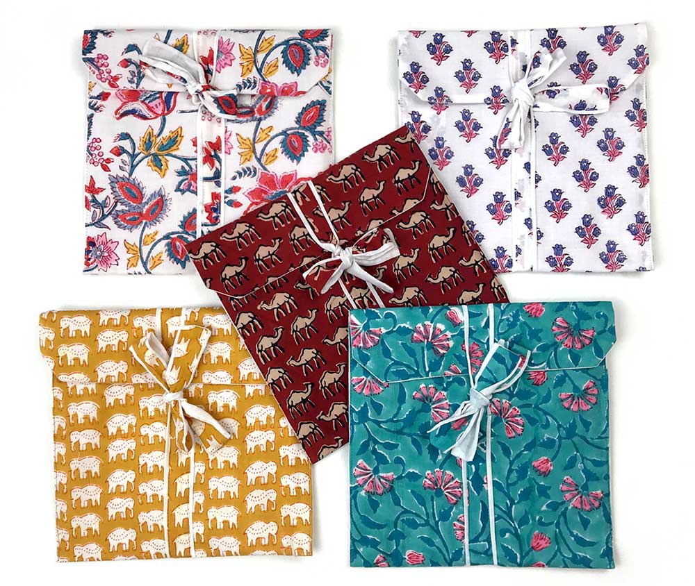 Five Awesome Blossom Pyjama sets in matching textile bags