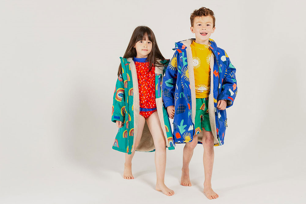 A boy and girl wearing bright coloured swimwear
