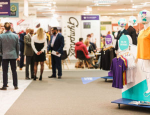 Visitors stood talking with exhibitors at The Schoolwear Show
