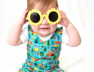 A young boy wearing yellow sunglasses
