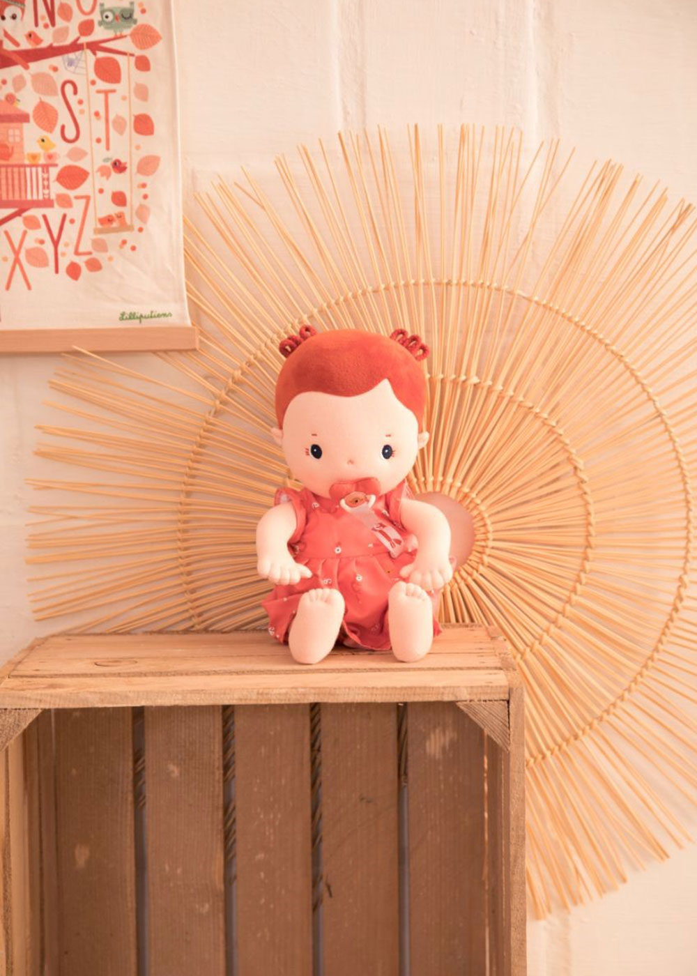 A rose doll sat on top of a wooden crate