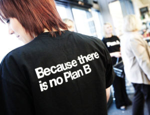 A lady wearing a black t-shirt with a 'Because there is no Plan B' on it