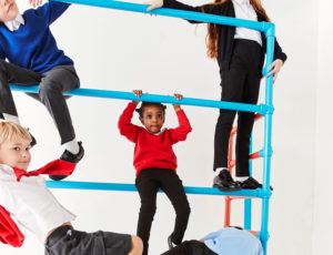 School children climbing on blue metal bars