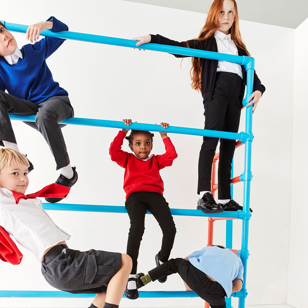 School children climbing on blue metal bars