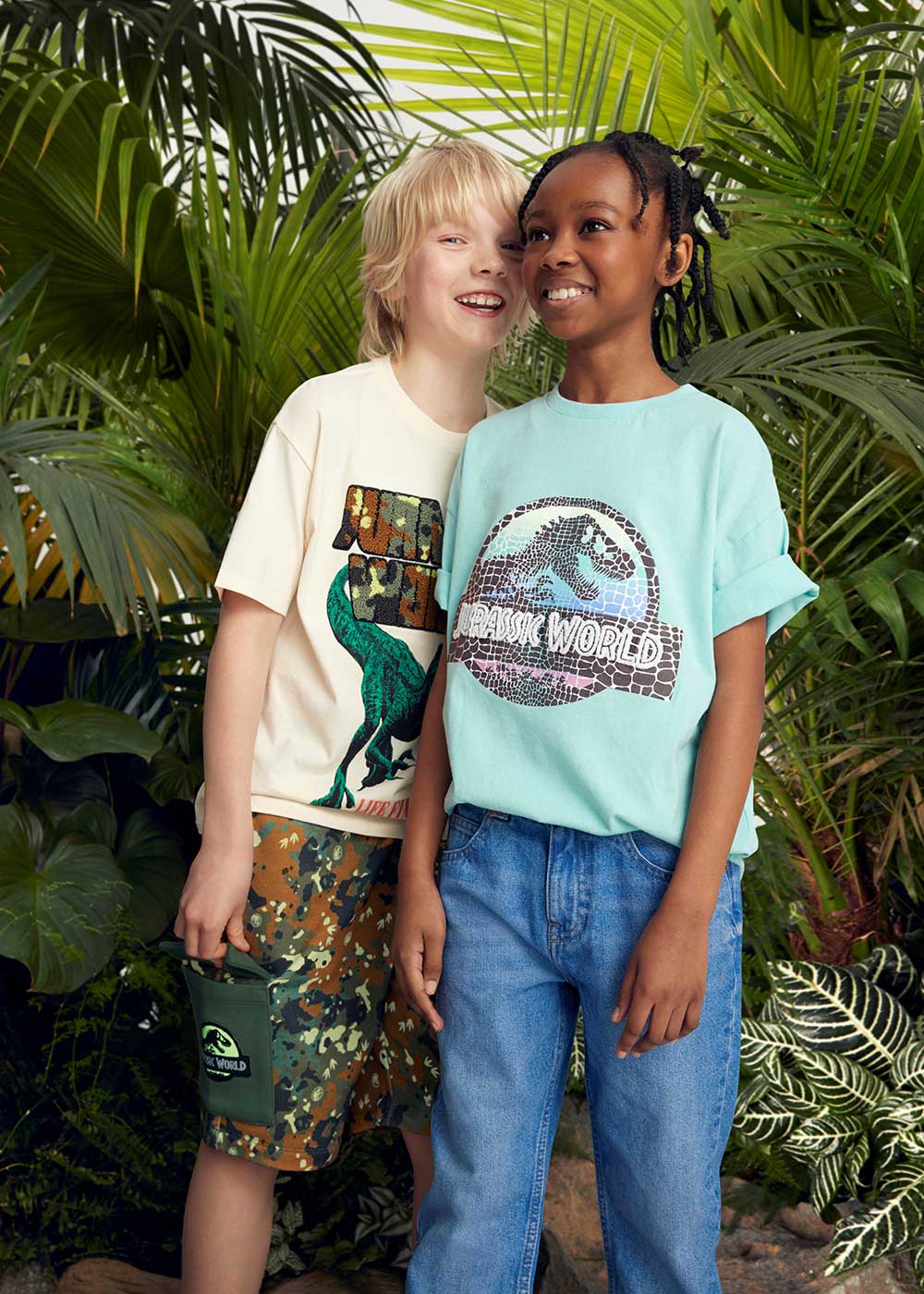 Two boys stood together wearing Jurassic World clothing